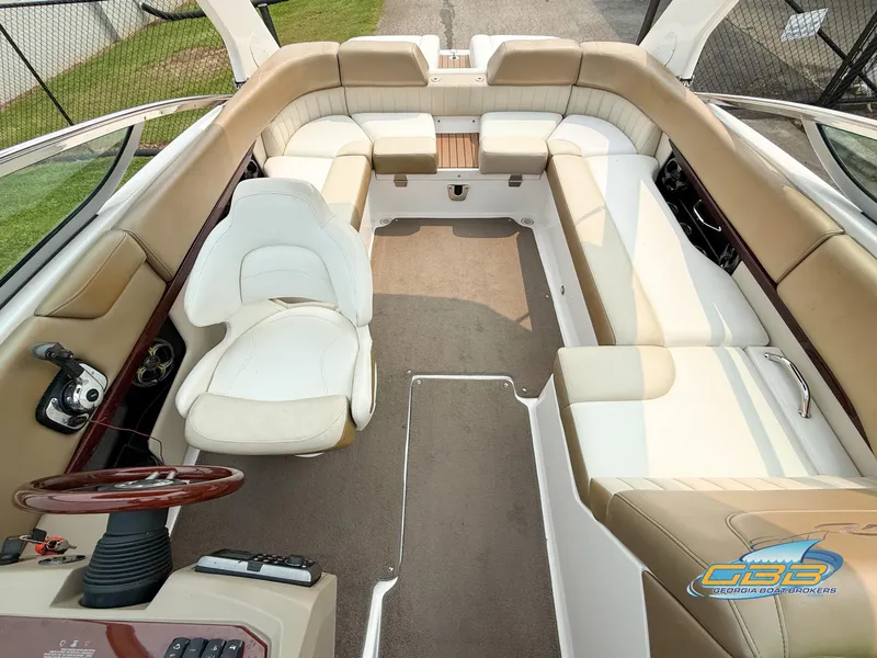 Slide: The Image of 2010 Regal 2300 Bowrider interior with beige seating and steering wheel. - 7