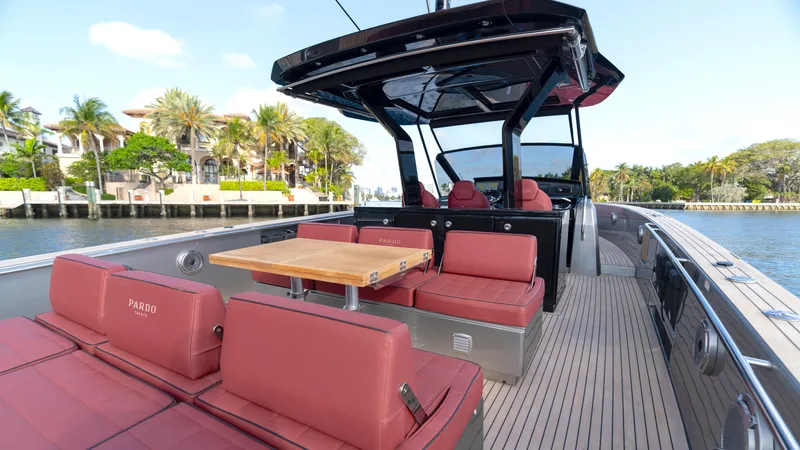 Slide: The Image of 2022 Pardo Yachts Pardo 43 with red seating, wooden table, and sleek design on a sunny day. - 16