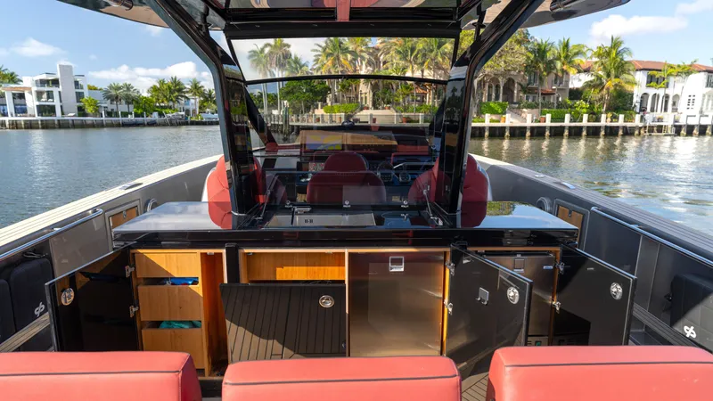 Slide: The Image of 2022 Pardo Yachts Pardo 43 interior with red seating, sleek design, and waterfront view. - 21