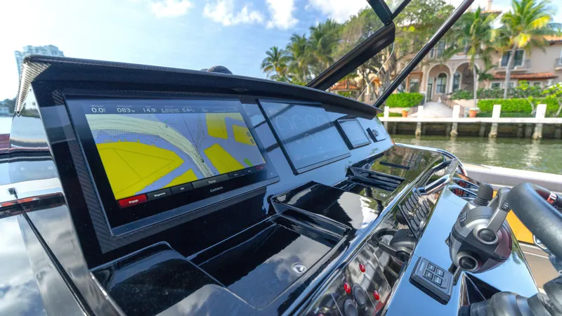Slide: The Image of Cockpit of 2022 Pardo Yachts Pardo 43 with navigation display, docked near waterfront homes. - 32