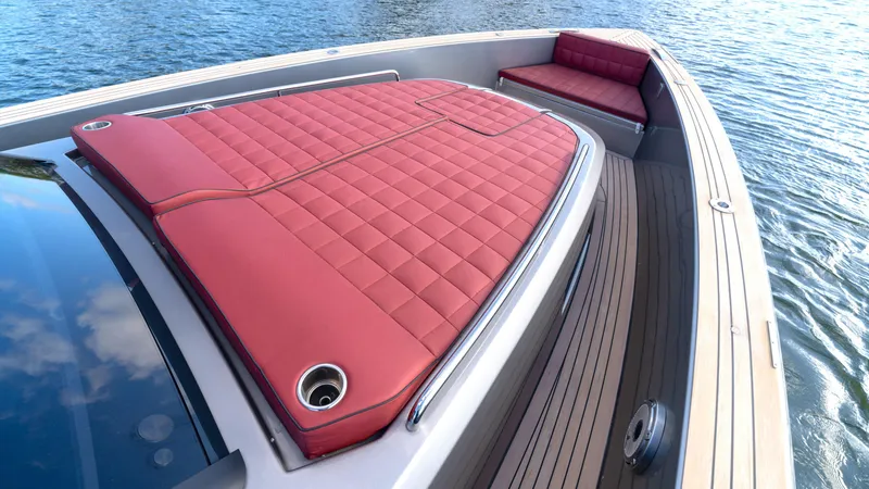 Slide: The Image of 2022 Pardo 43 yacht with red cushioned deck, sleek design, and wooden flooring on water. - 36