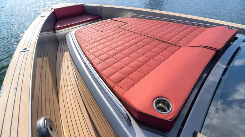 Slide: The Image of Luxurious 2022 Pardo 43 yacht with red cushioned sunbathing area and sleek wooden deck. - 38