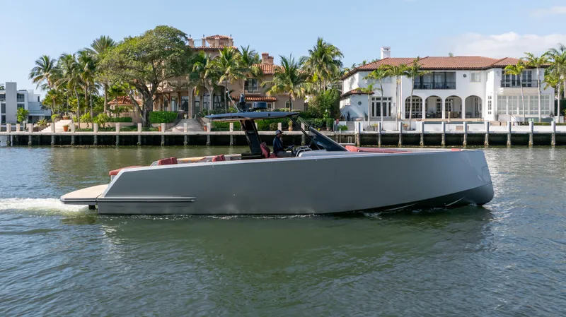 Slide: The Image of 2022 Pardo Yachts Pardo 43 cruising near waterfront homes, surrounded by palm trees. - 7