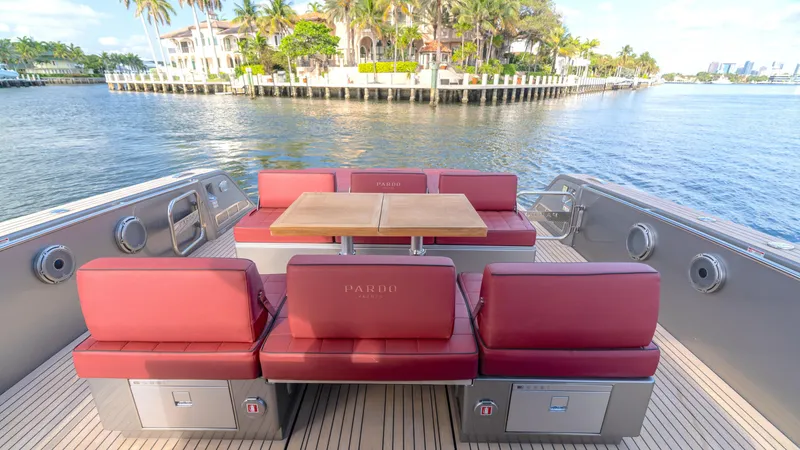 Slide: The Image of 2022 Pardo 43 yacht with red seating, wooden deck, and waterfront view. - 19