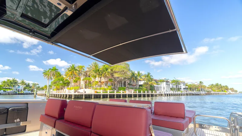 Slide: The Image of 2022 Pardo Yachts Pardo 43 with luxurious seating, cruising along a scenic waterfront. - 27