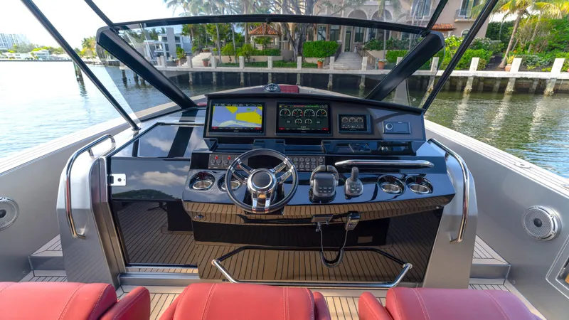 Slide: The Image of Cockpit of 2022 Pardo Yachts Pardo 43 with modern navigation equipment and red seating. - 30