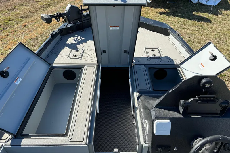 Slide: The Image of 2025 SeaArk Flex 19 boat interior with open storage compartments and control panel. - 11