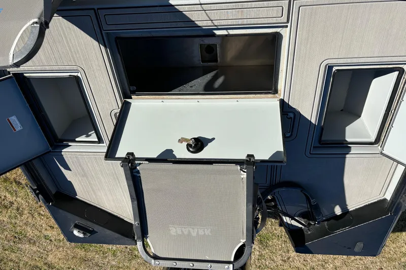 Slide: The Image of 2025 SeaArk Flex 19 boat interior with storage compartments and a foldable table. - 12