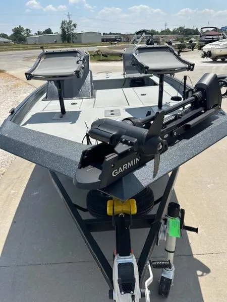 Slide: The Image of 2025 SeaArk Flex 19 boat with Garmin equipment, parked outdoors on grass. - 3