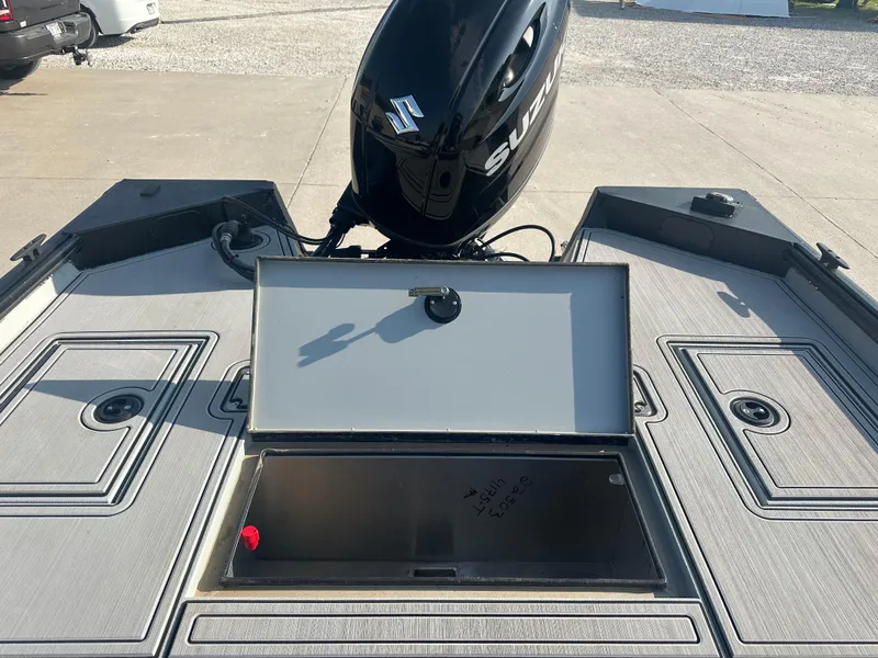 Slide: The Image of 2025 SeaArk Flex 19 boat with powerful outboard motor on grassy field. - 5