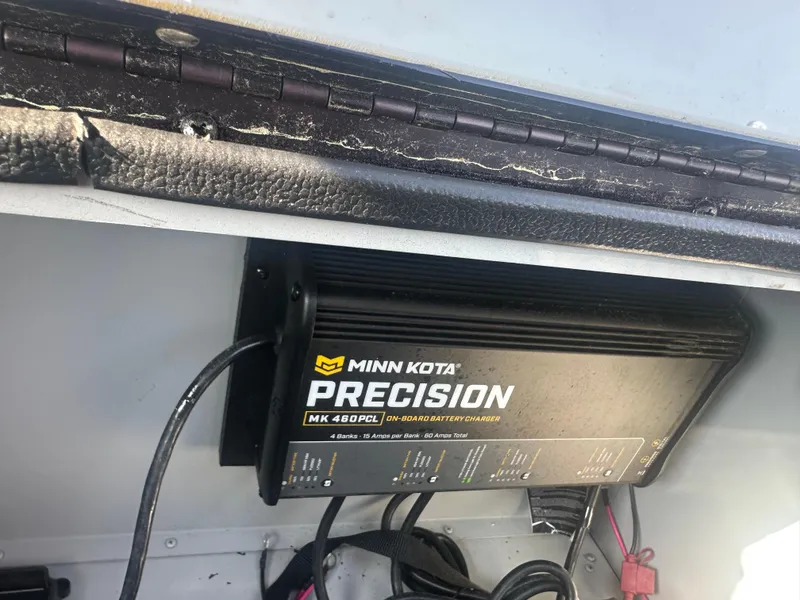 Slide: The Image of 2025 SeaArk Flex 19 boat interior with steering wheel and seating on grassy background. - 8