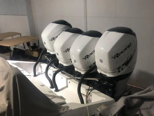Slide: The Image of Four powerful outboard engines on a 2019 Midnight Express 39 Cuddy boat. - 14