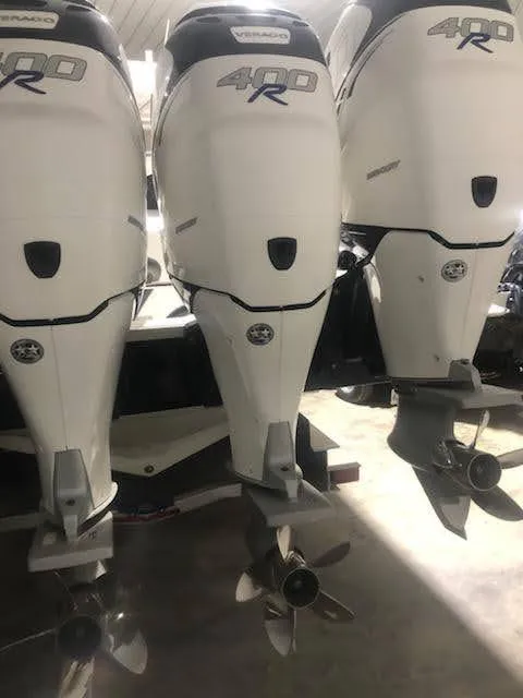 Slide: The Image of 2019 Midnight Express 39 Cuddy with triple 400R outboard engines in a garage. - 15