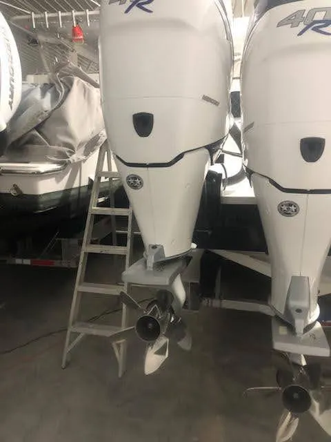 Slide: The Image of 2019 Midnight Express 39 Cuddy boat engines in storage, featuring dual outboard motors. - 16