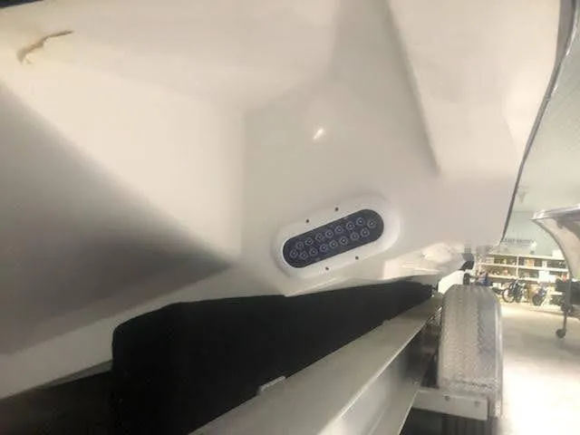 Slide: The Image of 2019 Midnight Express 39 Cuddy boat hull with LED lights on trailer. - 19