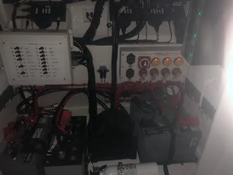 Slide: The Image of Electrical system of a 2019 Midnight Express 39 Cuddy boat, featuring batteries and control panels. - 20