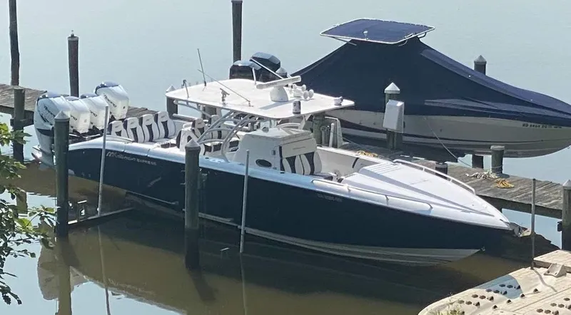 Slide: The Image of 2019 Midnight Express 39 Cuddy boat docked, featuring sleek design and powerful engines. - 26