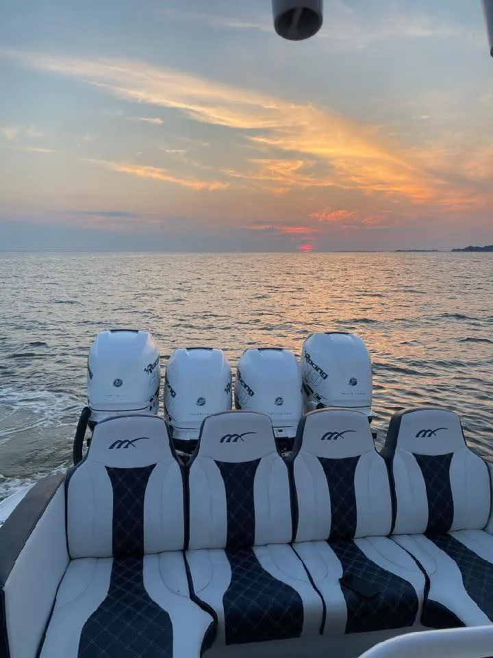 Slide: The Image of 2019 Midnight Express 39 Cuddy boat at sunset on the ocean. - 27