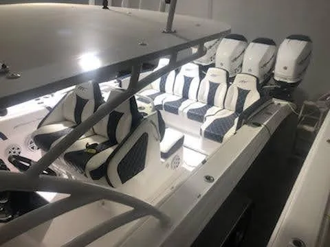 Slide: The Image of 2019 Midnight Express 39 Cuddy boat interior with luxurious seating and multiple engines. - 4