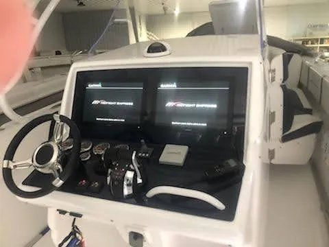 Slide: The Image of 2019 Midnight Express 39 Cuddy boat dashboard with dual screens and steering wheel. - 6
