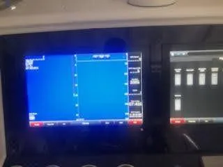 Slide: The Image of Dashboard of a 2019 Midnight Express 39 Cuddy boat with navigation screens. - 7