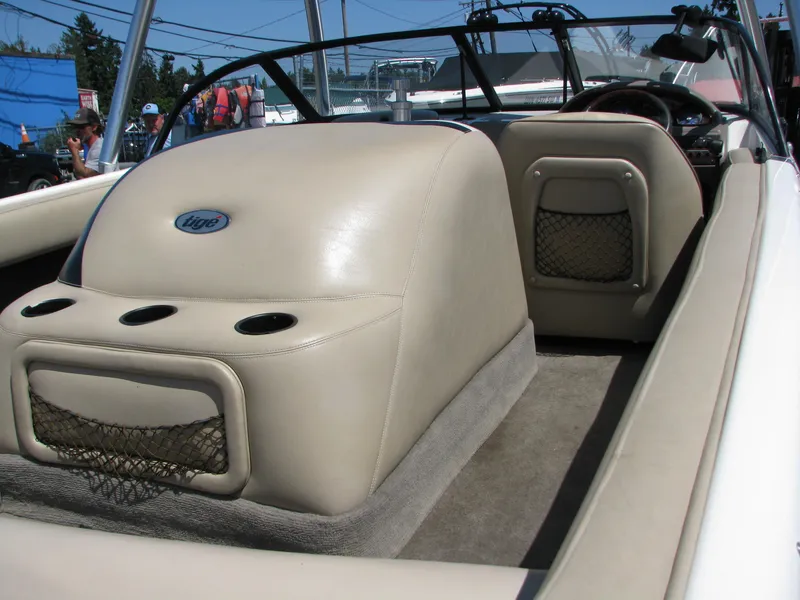 Slide: The Image of 2001 Tigé 20ci boat interior with beige seating and storage compartments. - 11