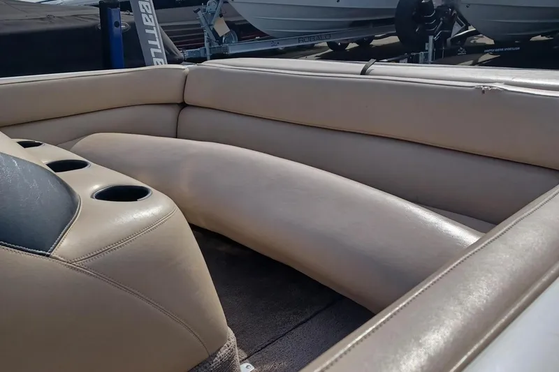 Slide: The Image of Interior seating of a 2001 Tigé 20ci boat with beige upholstery and cup holders. - 14