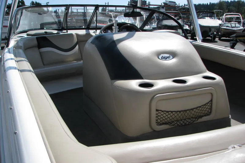 Slide: The Image of 2001 Tigé 20ci boat interior with beige seating and cup holders. - 17