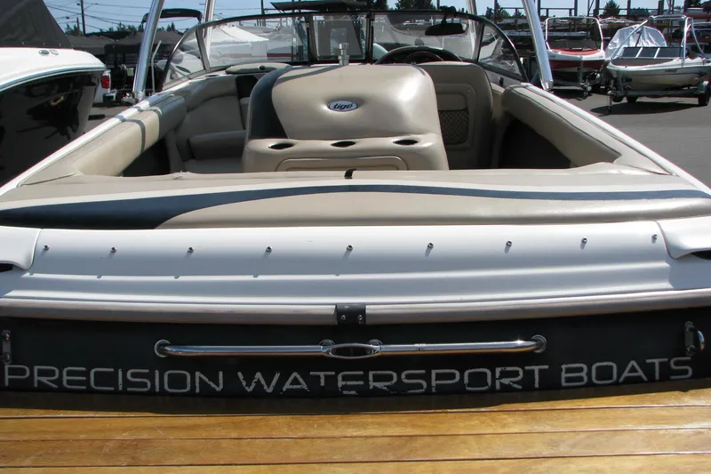 Slide: The Image of 2001 Tigé 20ci watersport boat with beige interior, docked at a marina. - 18