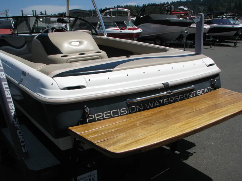 Slide: The Image of 2001 Tigé 20ci boat with wooden swim platform, parked in a marina. - 19