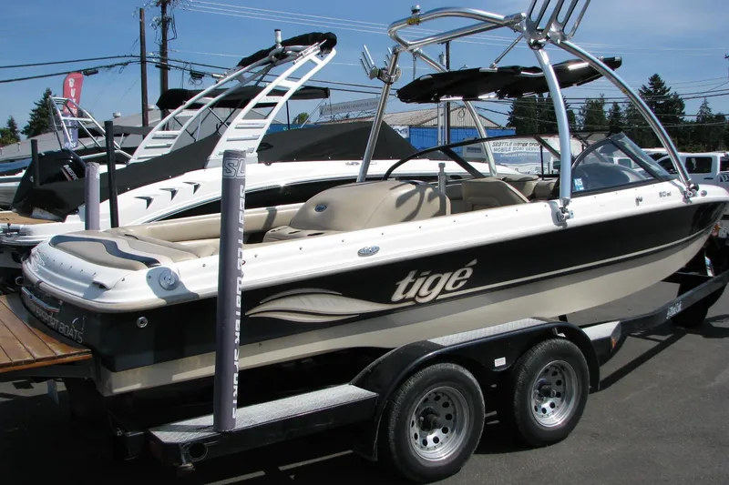 Slide: The Image of 2001 Tigé 20ci boat on trailer, featuring sleek design and wakeboard tower. - 2