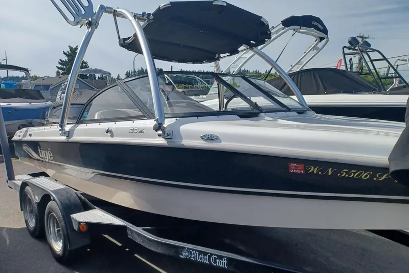 Slide: The Image of 2001 Tigé 20ci boat on trailer, featuring sleek design and wakeboard tower. - 3