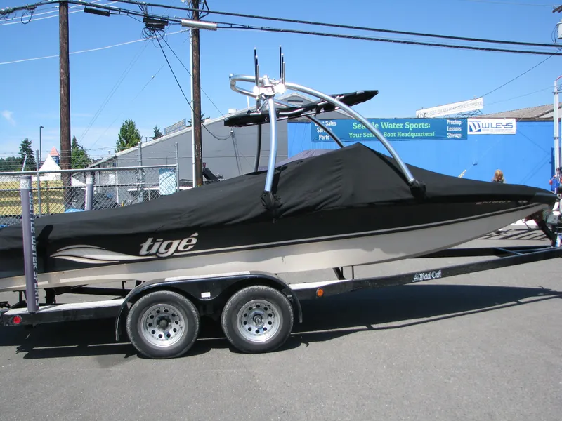 Slide: The Image of 2001 Tigé 20ci boat on trailer, covered, with wakeboard tower, parked outdoors. - 4