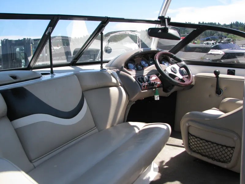 Slide: The Image of Interior of 2001 Tigé 20ci boat with steering wheel and seating. - 8