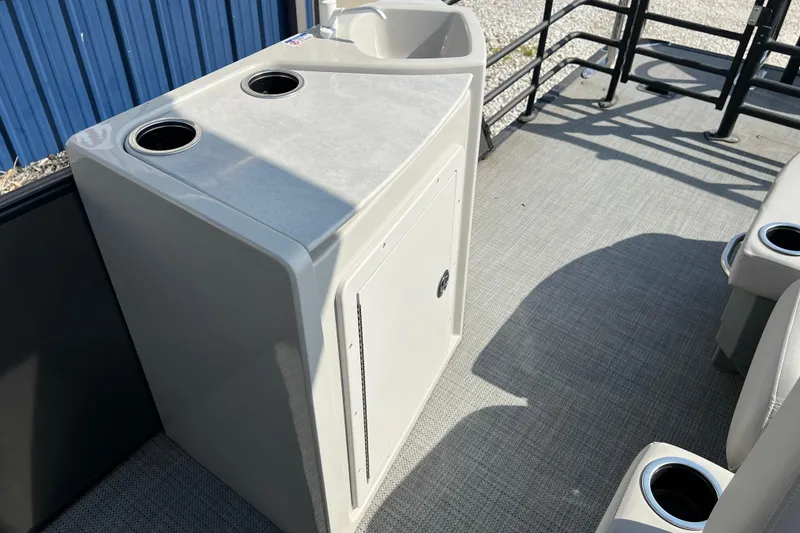 Slide: The Image of 2025 Sylvan L-3 DLZ boat interior with cup holders and storage compartment. - 19