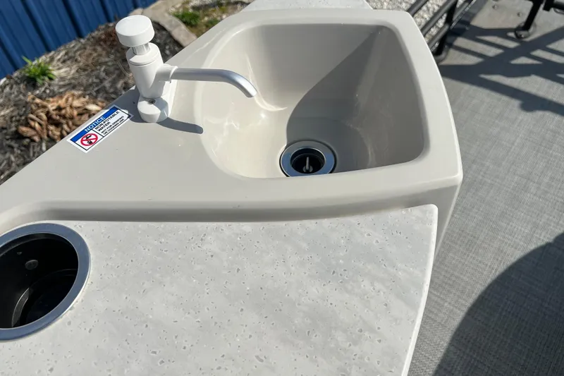 Slide: The Image of 2025 Sylvan L-3 DLZ boat sink with faucet, outdoor setting. - 20