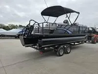 Slide: The Image of 2025 Sylvan L-3 DLZ pontoon boat on trailer, parked outdoors. - 5
