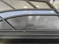 Slide: The Image of 2025 Sylvan L-3 DLZ boat canopy with sleek, modern design and tinted panels. - 8