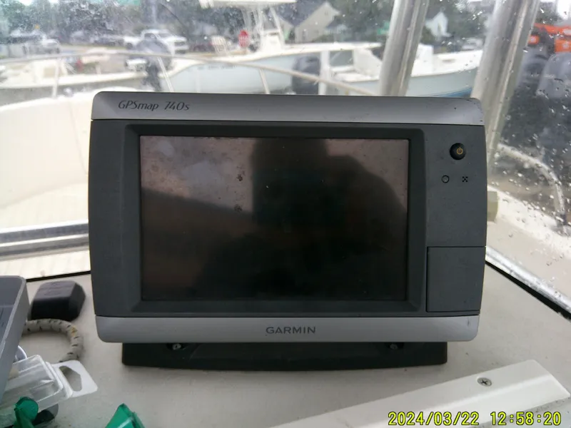 Slide: The Image of 2007 Cobia 214 CC boat interior with white seating and storage compartments. - 10