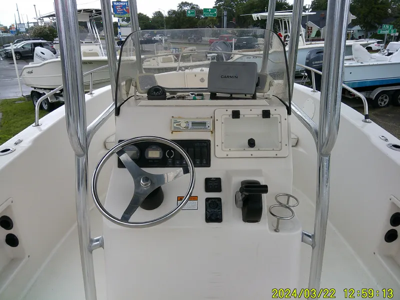 Slide: The Image of 2007 Cobia 214 CC boat storage compartment with open lid, showing interior details. - 13