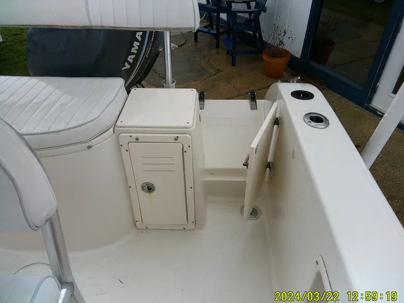 Slide: The Image of 2007 Cobia 214 CC boat console with steering wheel and navigation equipment. - 14