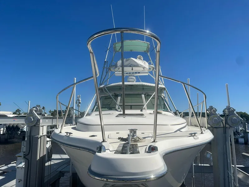 Slide: The Image of 1995 Tiara Sport 3100 yacht docked under clear blue sky. - 2