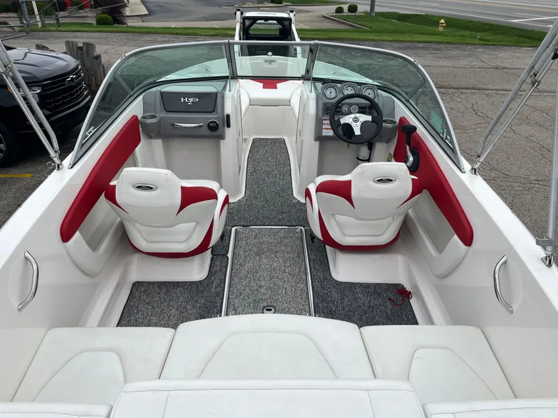 Slide: The Image of 2014 Chaparral 19 Sport H2O boat interior with red and white seating, steering wheel, and dashboard. - 1