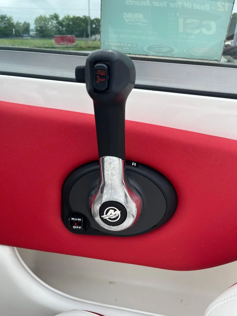 Slide: The Image of Throttle control lever on a 2014 Chaparral 19 Sport H2O boat, red interior. - 14