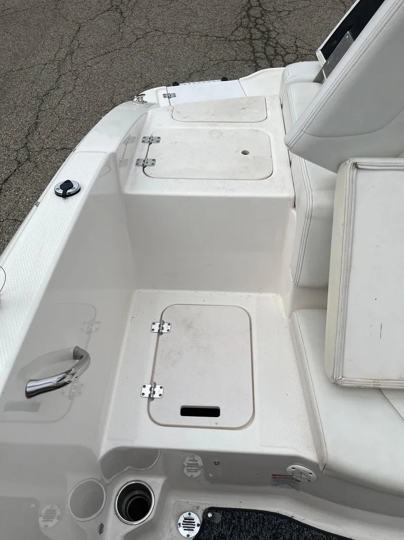 Slide: The Image of 2014 Chaparral 19 Sport H2O boat interior with storage compartments and seating. - 16