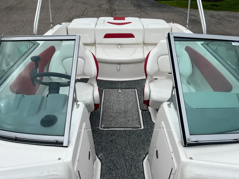 Slide: The Image of 2014 Chaparral 19 Sport H2O boat interior with white and red seating, dual windshields. - 5