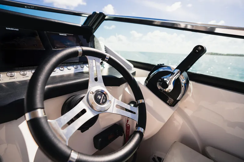 Slide: The Image of Steering wheel and controls of 2025 Ventura V300 Crossover boat, ocean view. - 3