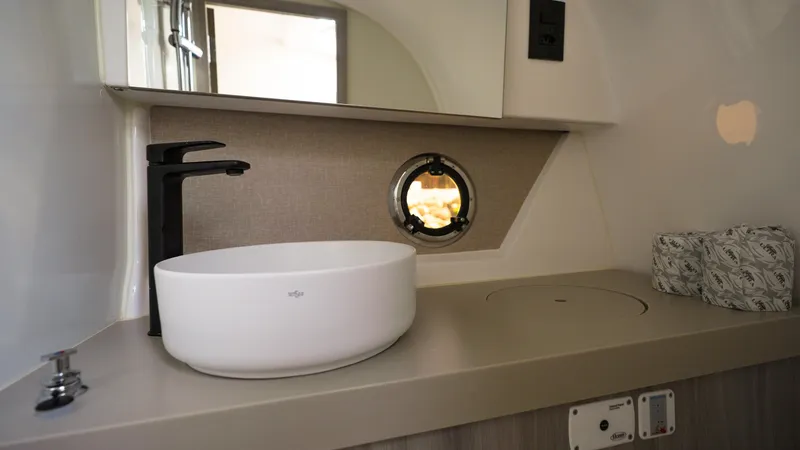 Slide: The Image of Modern bathroom interior in 2025 Ventura V300 Crossover RV with sleek sink and faucet. - 5