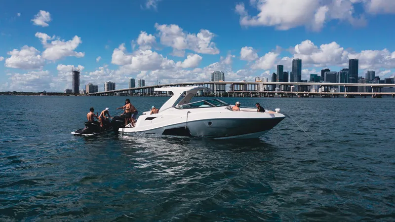 Slide: The Image of 2025 Ventura V300 Crossover boat on water with city skyline in background. - 7