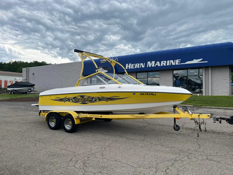 The Image of 2004 Tigé 20V Limited Edition boat in yellow, parked at Hern Marine dealership. - 0